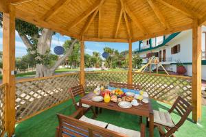 a wooden table with food on it under a pavilion at Villas Marianna in Kalavárda