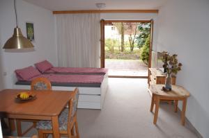 a living room with a table and a couch at Haus Rottachbrücke May in Tegernsee