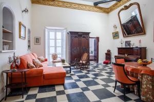 a living room with a couch and a table at Suites Machado in Seville