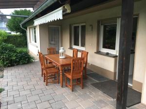 a wooden table and chairs on a patio at Zwischen Köln und Bonn, Central Mitte in Troisdorf