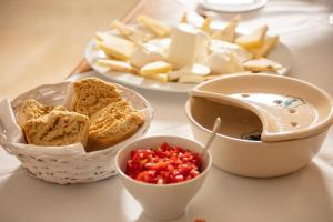a table with a plate of food with bread and salsa at Masseria Mongiò dell'Elefante in Otranto