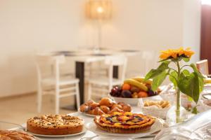 a table with pies and other foods on it at Masseria Mongiò dell'Elefante in Otranto