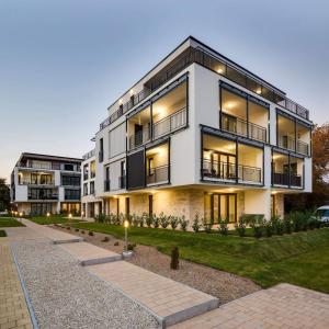 a large white building with lights on at Royal Apartman in Csopak