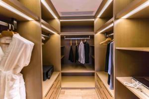 a walk in closet with brown walls and wooden closets at Somerset Grandview Shenzhen in Shenzhen
