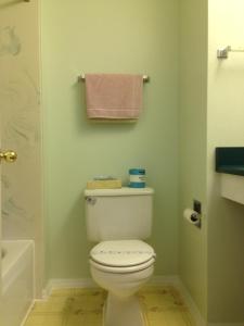 a bathroom with a toilet and a towel rack at Sweet Breeze Inn Grants Pass in Grants Pass