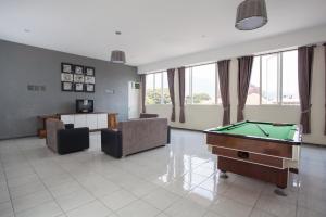 a living room with a pool table in it at RedDoorz near Museum Angkut Batu 2 in Malang