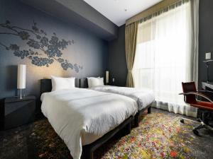 Postel nebo postele na pokoji v ubytování Sotetsu Grand Fresa Tokyo-Bay Ariake