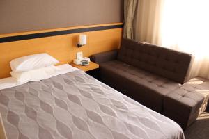 Postel nebo postele na pokoji v ubytování Grand Hotel Hakusan + 25 fotografií