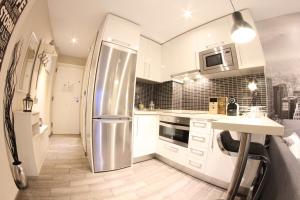 a kitchen with a stainless steel refrigerator and a counter at Lovely Studio New York Design in Torremolinos