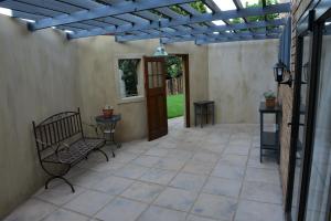 a patio with a bench and a pergola at 250onIndus in Pretoria