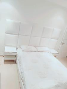 a white room with a bed and two white cabinets at LUXURY SEA VIEW APT 3 ROOMS IN LUXURY RESIDENCE in Eilat
