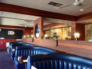 a row of blue leather chairs in a restaurant at Moby Dick Inn in Prince Rupert