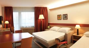 Postel nebo postele na pokoji v ubytování Garni Hotel Savica - Sava Hotels & Resorts