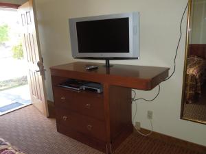 a tv on top of a dresser with a television on it at Monticello Motel in Portland
