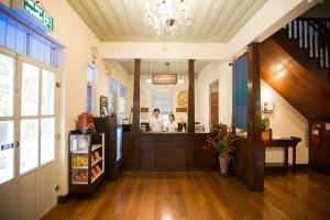 a man and a woman standing at the counter of a restaurant at Eco Resort Chiang Mai in Chiang Mai