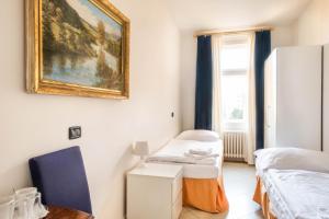 a room with two beds and a painting on the wall at La Fenice in Prague