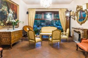 a living room with a table and chairs and a fireplace at La Fenice in Prague