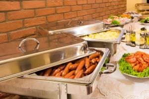 a buffet with several trays of food on a table at La Fenice in Prague