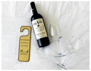 a bottle of wine next to two wine glasses at "Palazzo" in Kostanay