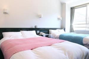 Postel nebo postele na pokoji v ubytování Sora no Mori Hotel Hanagori