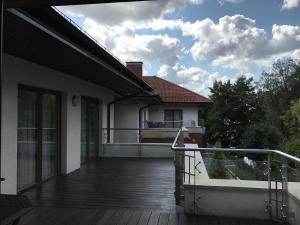 a balcony of a house with a deck at APARTAMENT 304 Willa Port in Ostróda