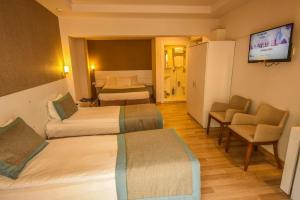 Postel nebo postele na pokoji v ubytování ParionHouse Hotel