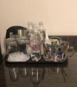 a bottle of water and a spoon on a table at Non-stop hotel in Boryspil