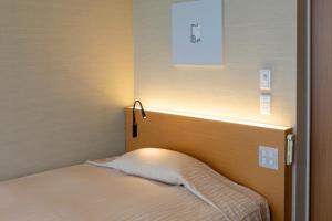 Postel nebo postele na pokoji v ubytování Hotel Landmark Wakayama