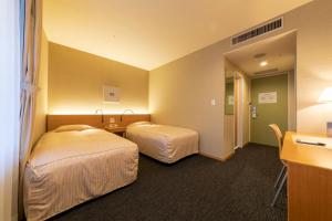 Postel nebo postele na pokoji v ubytování Hotel Landmark Wakayama