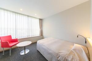 Postel nebo postele na pokoji v ubytování Hotel Landmark Wakayama