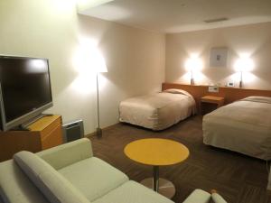 Postel nebo postele na pokoji v ubytování Hotel Landmark Wakayama