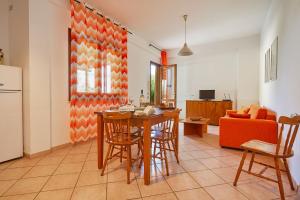 a kitchen and living room with a table and chairs at Case di Calamazzo in Scopello