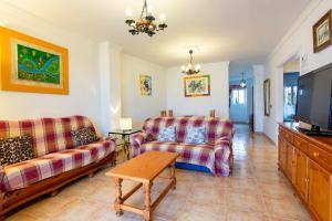 a living room with two couches and a flat screen tv at Carabeo P Milenio 1 piso 2 1 sea view in Nerja