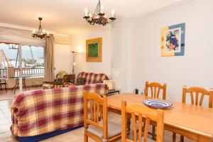 a living room with a table and a couch at Carabeo P Milenio 1 piso 2 1 sea view in Nerja