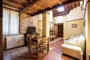 a living room with a table and a couch at Borgo Il Poggiaccio Residence in Sovicille