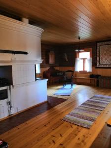 a living room with a fireplace and wooden floors at Rehto in Rovaniemi