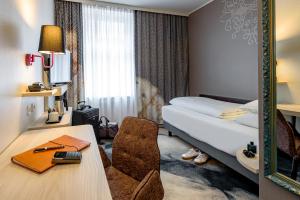 Postel nebo postele na pokoji v ubytování Mercure München am Olympiapark