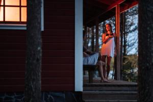 a woman standing on the porch of a house at Rehto in Rovaniemi +13 photos