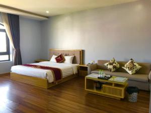 a hotel room with a bed and a couch at Phoenix3 Hotel Bắc ninh in Bắc Ninh