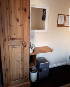 a bathroom with a sink and a wooden cabinet at Elmswood Guest House in South Shields