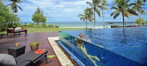 a swimming pool with a dolphin in the water at The Residence Zanzibar in Kizimkazi