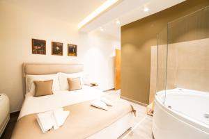 a bedroom with a bed and a bath tub at Belgrade Center Luxury Apartments in Belgrade +33 photos