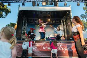 a group of children looking at performers on a stage at CAMPING BONNE ANSE PLAGE in La Palmyre