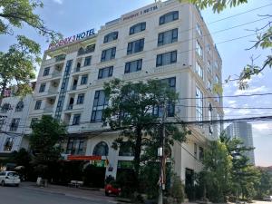 a white building with a sign on it at Phoenix3 Hotel Bắc ninh in Bắc Ninh