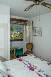 a bedroom with a bed and a window at Les Amandiers in Montreux