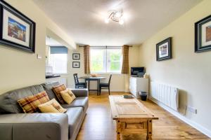 a living room with a couch and a table at Stunning Studio Apartment Castle View in Edinburgh