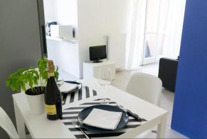 a dining table with a bottle of wine and a wine glass at C come Colorato in Como