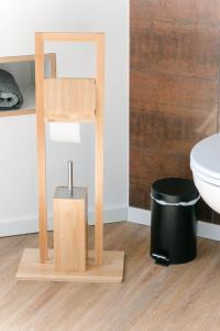 a bathroom with a wooden stand next to a toilet at Morgenröte in Sedlitz