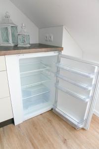 a white refrigerator with empty shelves in a kitchen at Morgenröte in Sedlitz