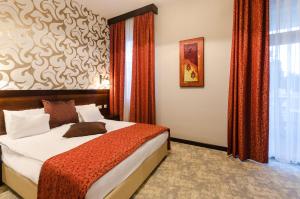 Postel nebo postele na pokoji v ubytování Hotel Aurum